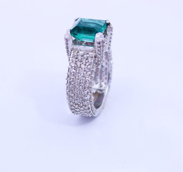 Diamond ring with green stone