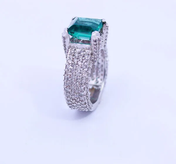 Diamond ring with green stone